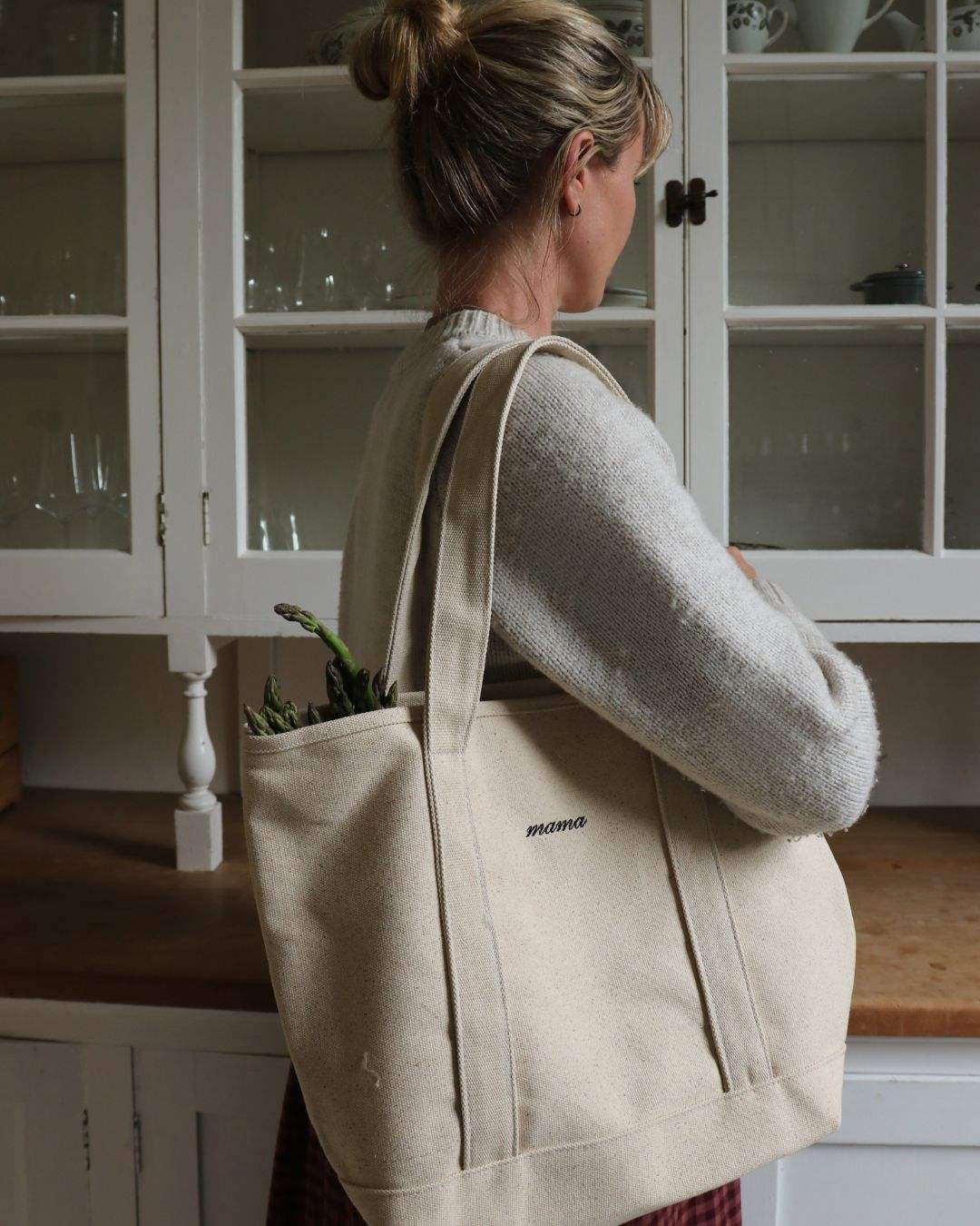 Personalised heavyweight canvas tote bag worn by woman in kitchen