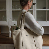 Personalised heavyweight canvas tote bag worn by woman in kitchen