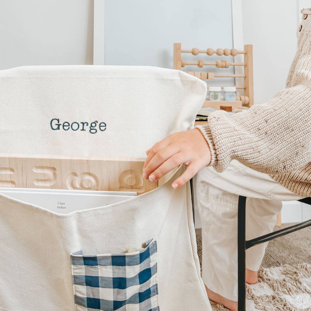 Personalised chair bag - canvas with gingham pocket for kids, featuring embroidered names.