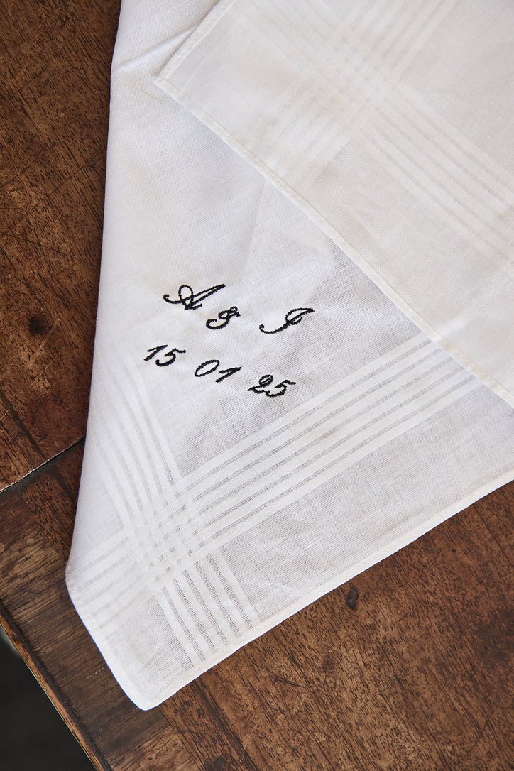 Personalized embroidered men's cotton handkerchief on wooden surface