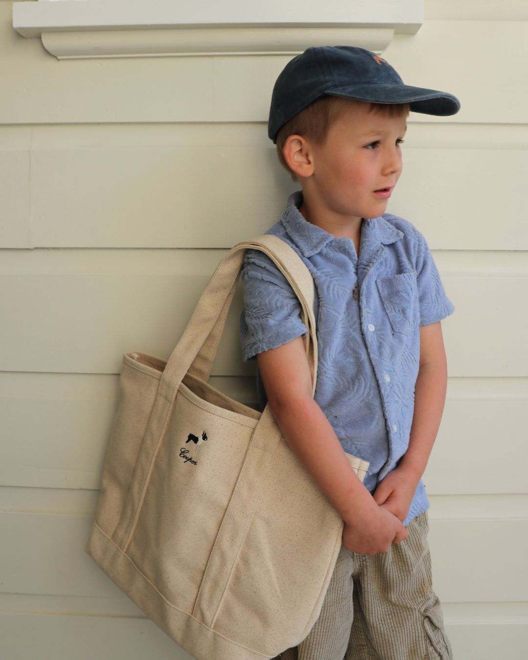 Personalised heavyweight canvas tote bag carried by young boy in casual outfit