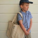 Personalised heavyweight canvas tote bag carried by young boy in casual outfit