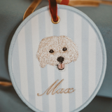 Personalised pet ornament with embroidered dog face and name Max on striped background, 10cm x 10cm.