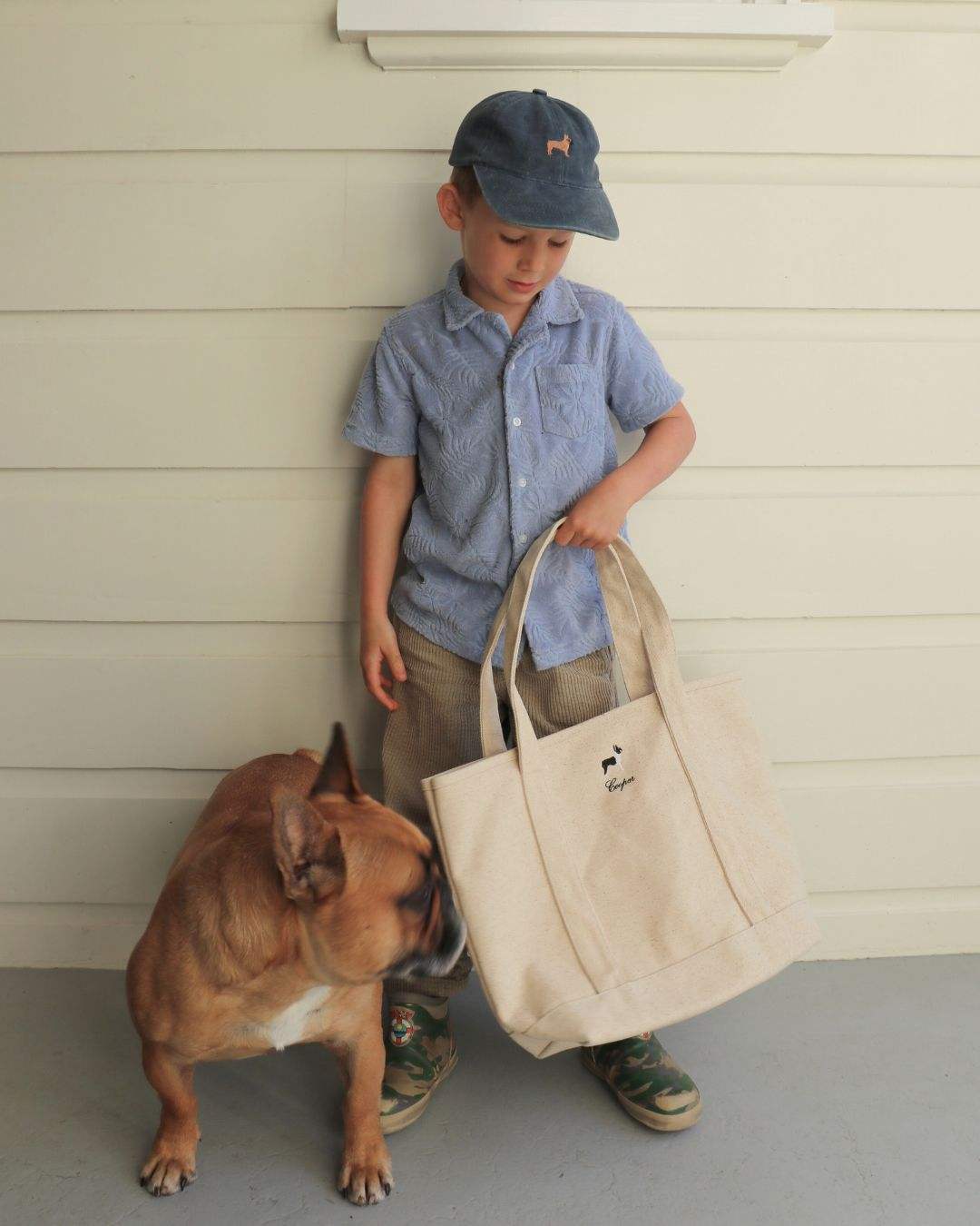 Child holding personalised heavyweight canvas tote bag with dog nearby