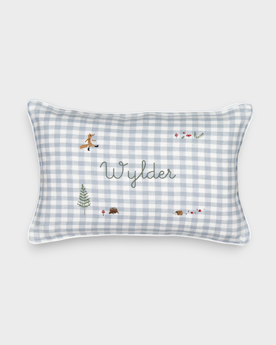 Rectangular Woodland Keepsake Linen Cushion with blue and white check pattern, embroidered with personalized name "Wylder" and small woodland animal and nature designs.