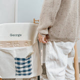 Personalised chair bag with gingham pocket on child's chair, durable canvas material.