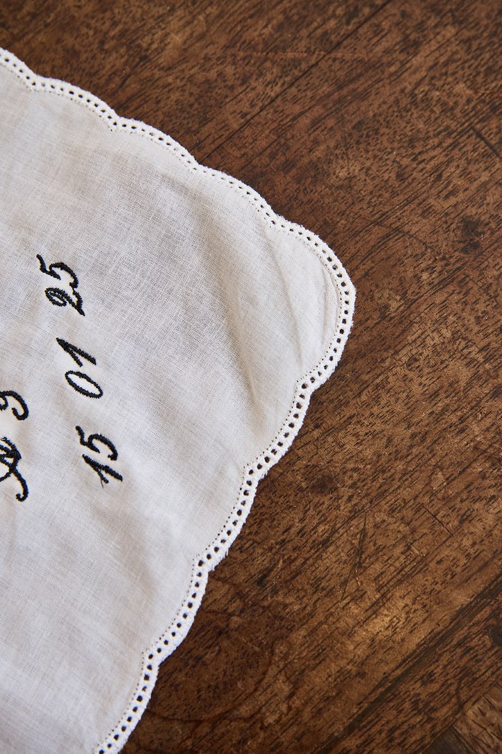 Delicate ladies handkerchief with scalloped edge and personalized embroidery on white cotton fabric
