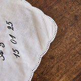 Delicate ladies handkerchief with scalloped edge and personalized embroidery on white cotton fabric