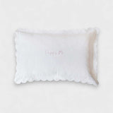 Organic cotton pillowcase with white scalloped edge and personalized embroidery.