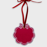 Red scalloped initials ornament with white embroidery and red velvet ribbon for hanging, 10cm x 10cm.
