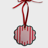 Personalised initials ornament with red stripes and green scalloped edge hanging on red velvet ribbon