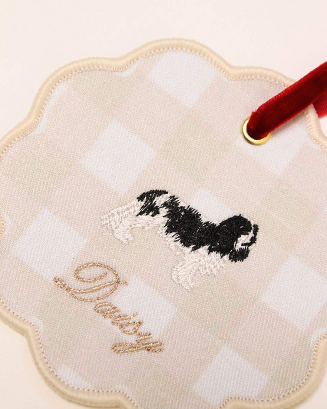 Personalised initials ornament with embroidered dog design and red velvet ribbon for holiday decor