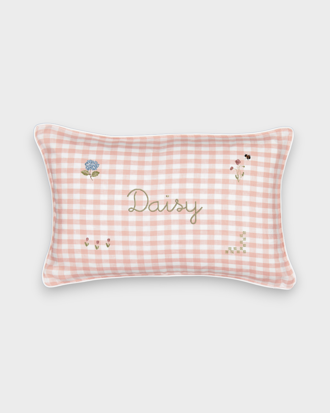 Botanical linen cushion with pink gingham pattern, hand-embroidered floral designs, and personalized name embroidery