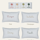 Botanical Linen Cushion with hand-embroidered names in pink, champagne, willow, and dark teal on blue check fabric, made from 100% European flax linen.