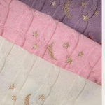 Merino baby blanket with moon and stars design, embroidered details on soft, breathable wool.