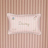 Botanical Linen Cushion with pink gingham pattern, floral embroidery, personalized name "Daisy," white piping, and soft removable cover.