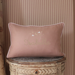 Moon and Stars Cushion with embroidered name, hand-stitched moon and stars design on soft pink fabric with white piping.