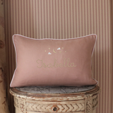 Moon and Stars Cushion with embroidered name, hand-stitched moon and stars design on soft pink fabric with white piping.
