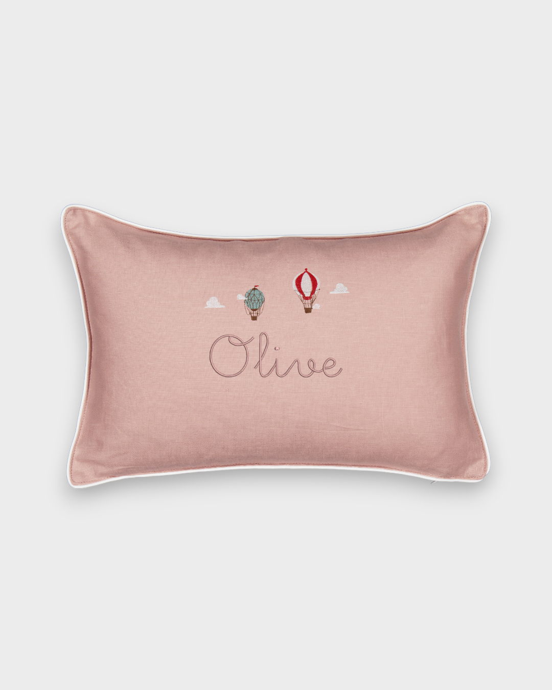 Pink linen up and away cushion with embroidered vintage hot air balloons and personalized name "Olive" with white piping border