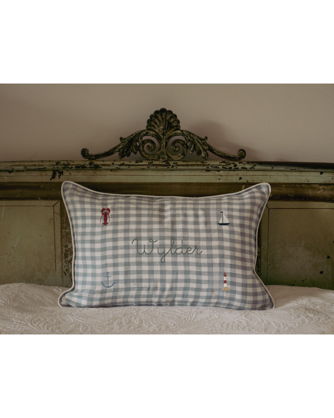 Duck egg blue gingham linen nautical cushion with embroidered sea-themed designs and personalized name "Wylder"