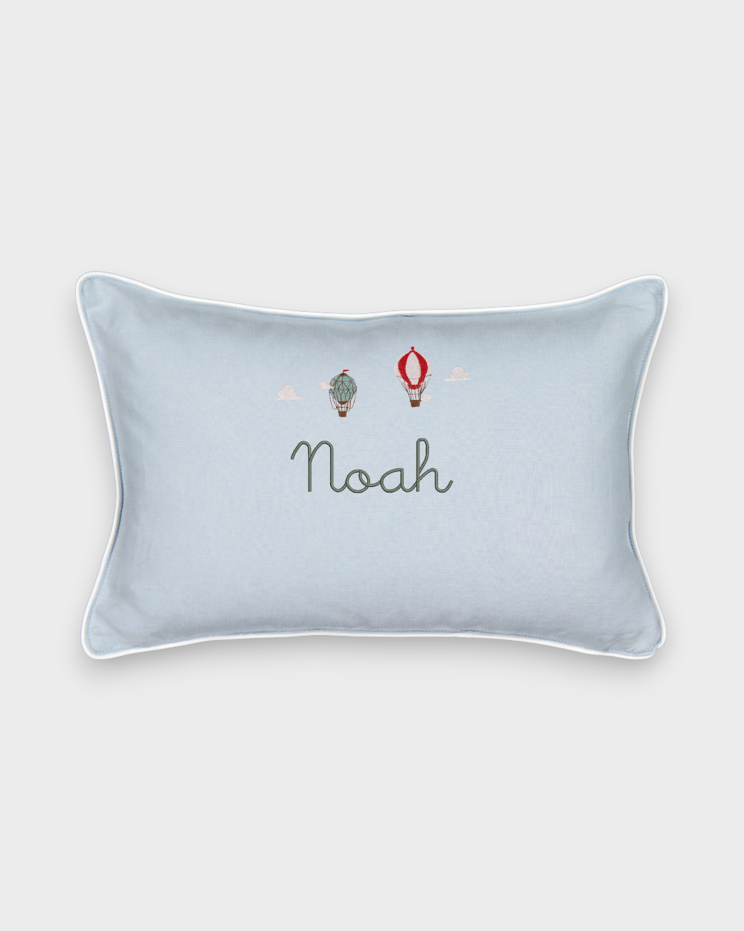 Duck egg blue linen cushion with embroidered vintage hot air balloons and personalized name Noah, white piping, 30x45cm.