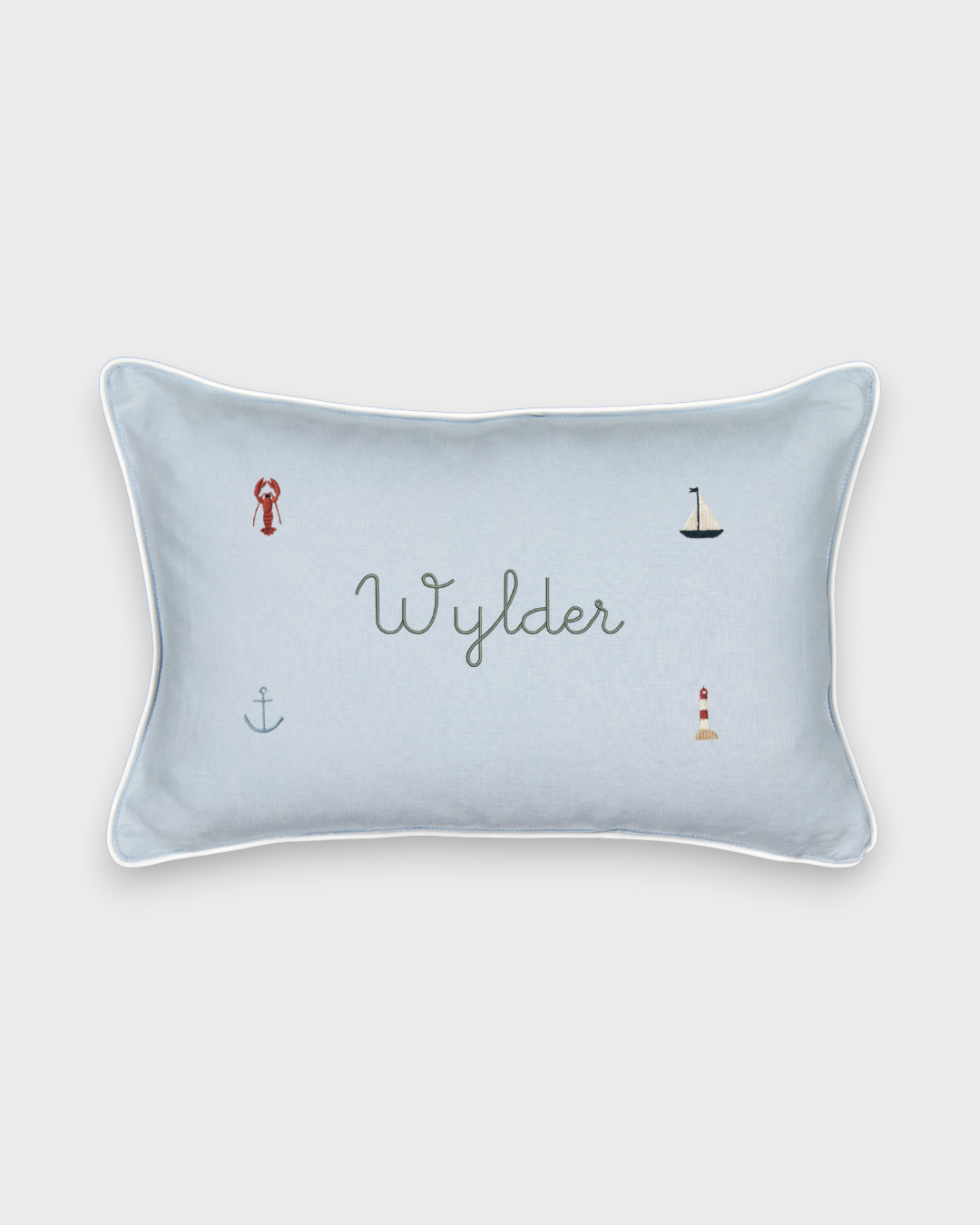 Nautical cushion in duck egg blue gingham linen with embroidered sea-themed designs and personalized name, white piping, removable cover.