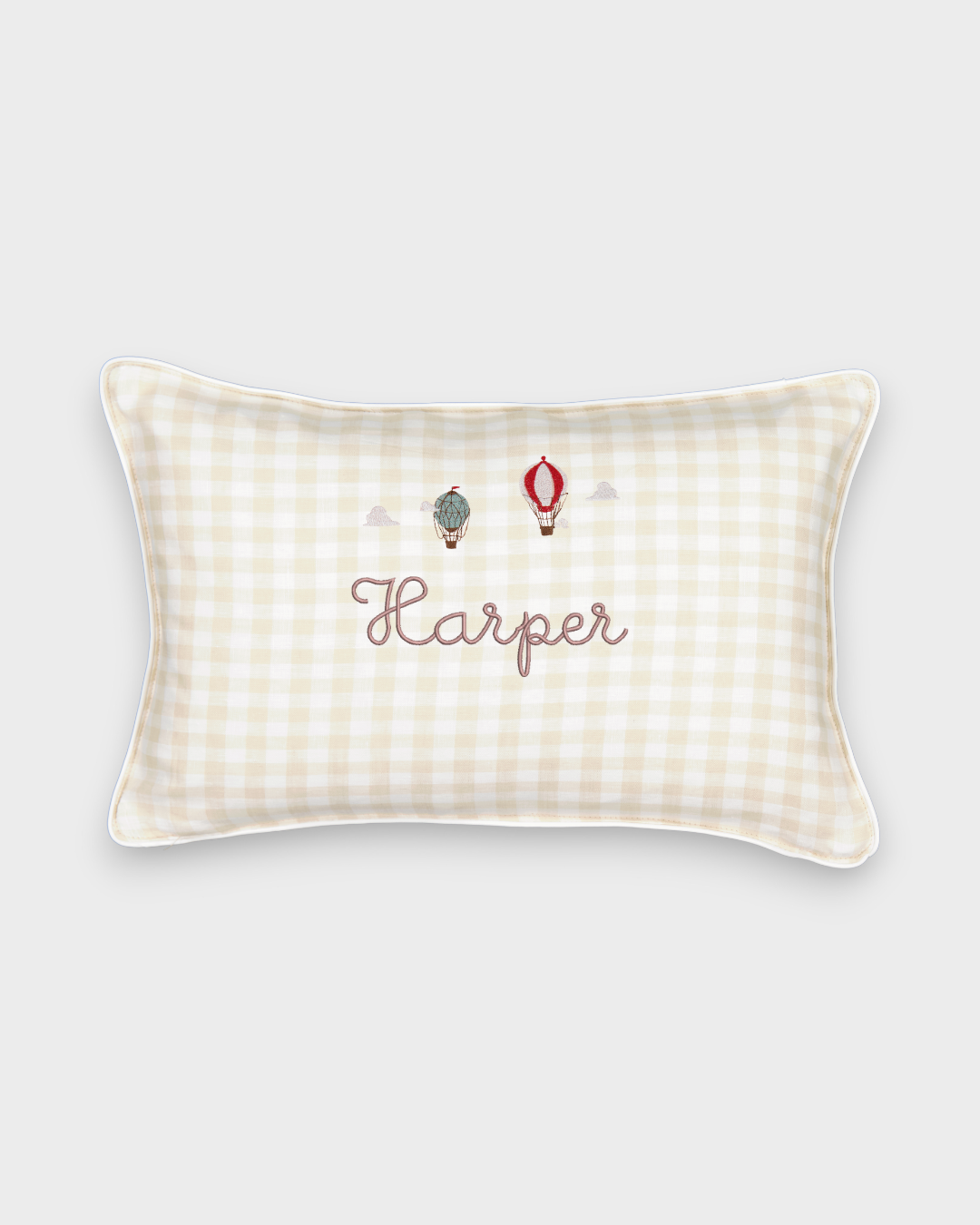 Rectangular linen cushion with embroidered vintage hot air balloons and personalized name on cream gingham fabric with white piping