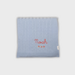 Blue merino baby blanket with personalized embroidery and rosette design