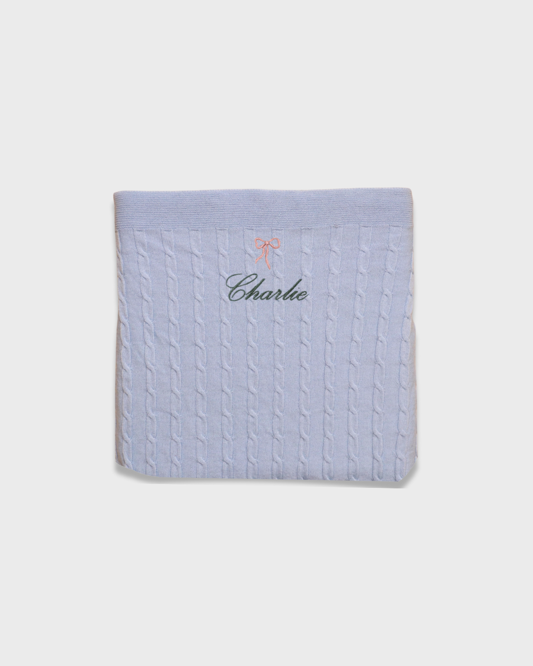 Personalized merino baby blanket with embroidered vintage bow and name "Charlie" in soft wool fibers