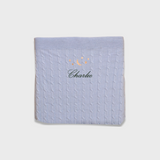 Soft blue Merino baby blanket with embroidered moon and stars design and personalized name Charlie.