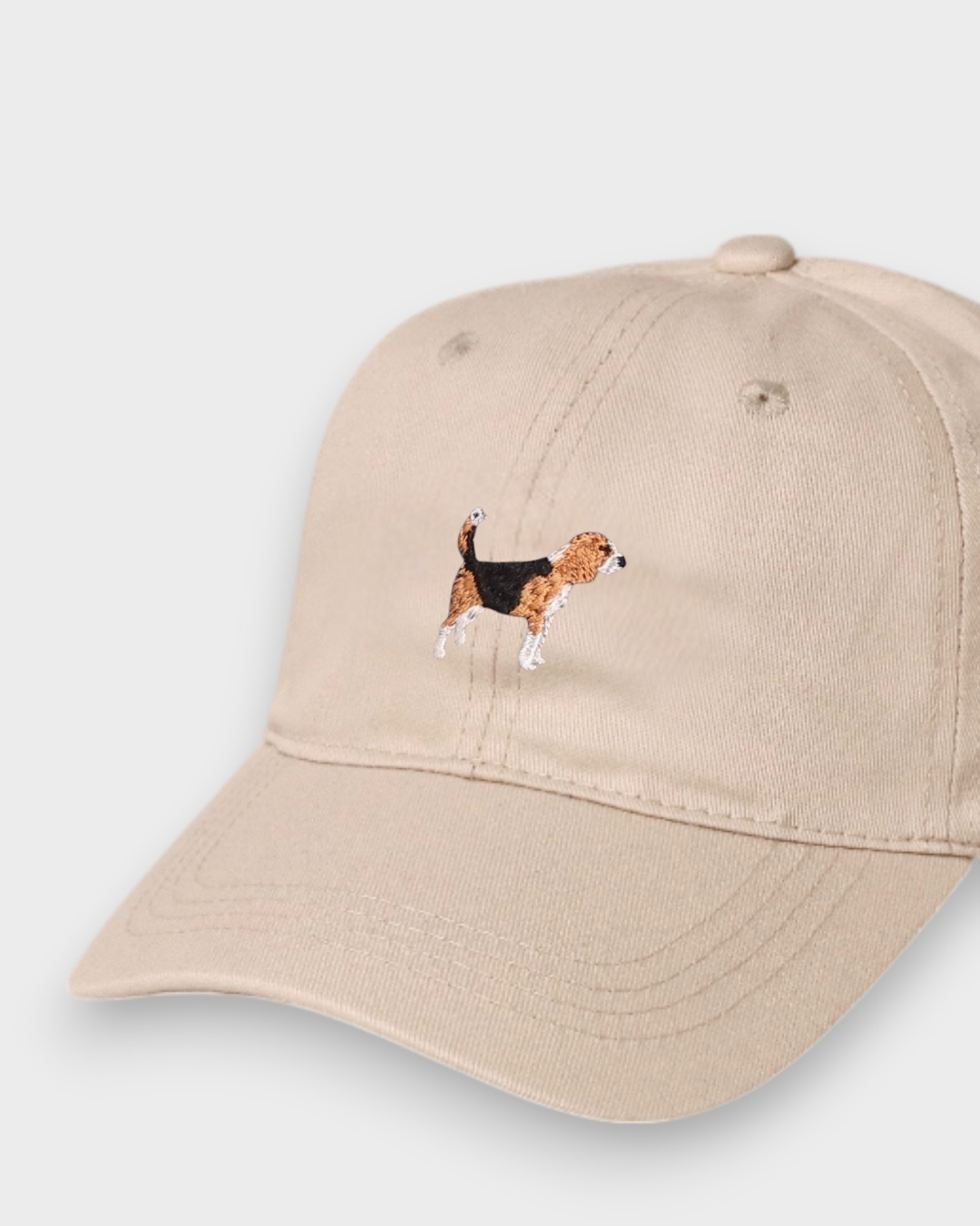Beige baseball cap with embroidered hand-drawn Beagle design, personalised embroidery option on back, made of 100% washed cotton.