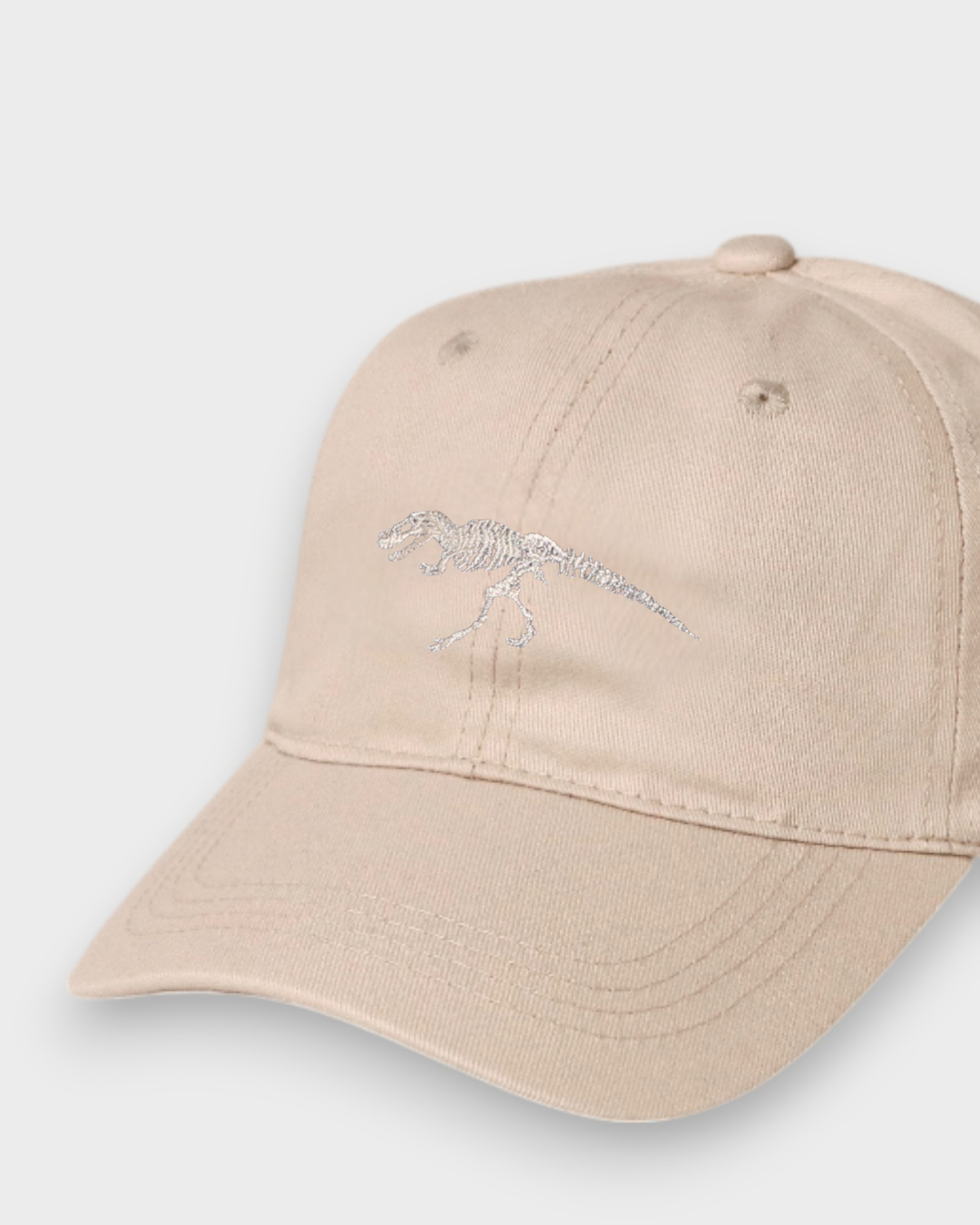 Beige T-Rex embroidered personalised baseball hat made of 100% washed cotton in kids and adult sizes