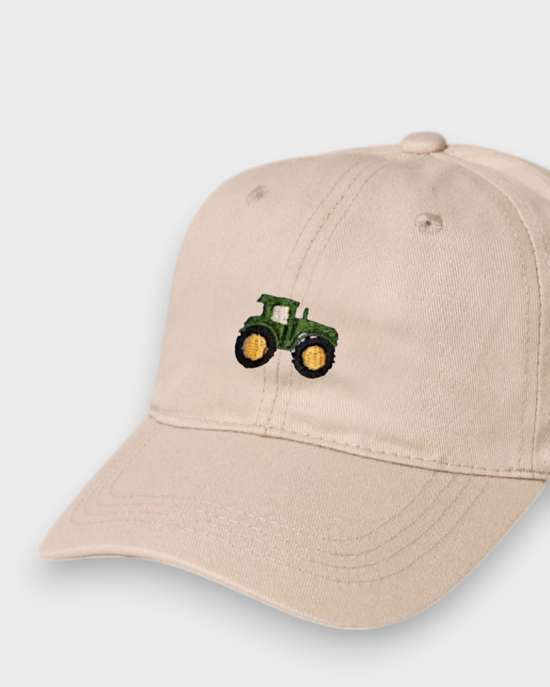 Beige Tractor Personalised Hat with hand-drawn green tractor embroidery, classic baseball fit, made of 100% washed cotton.