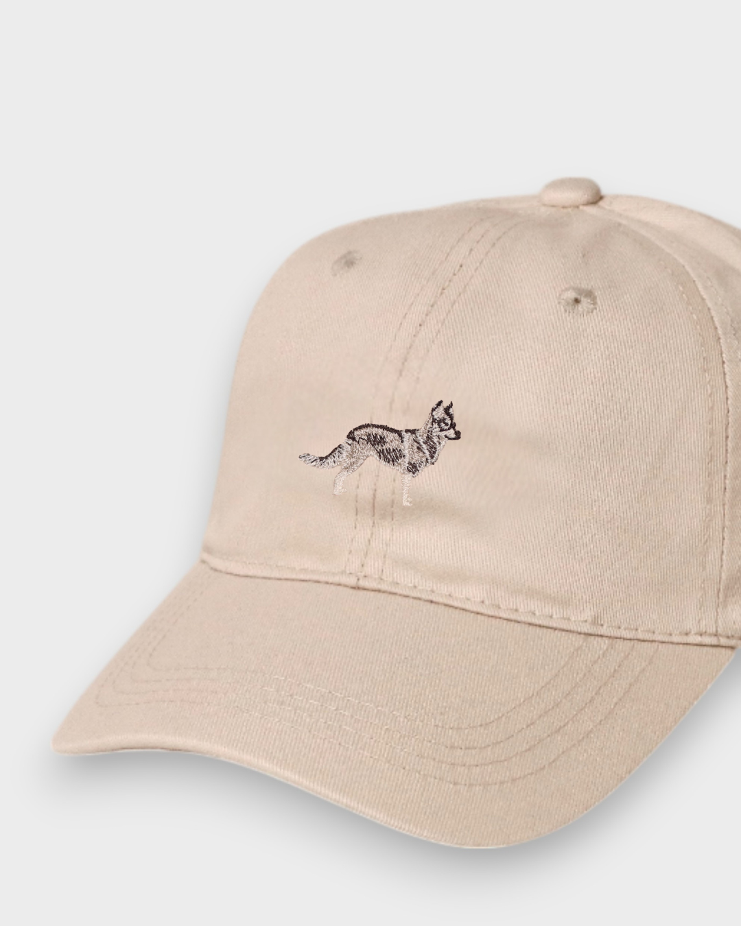 Beige Husky Personalised Hat with hand-drawn embroidered Husky design on front, made of 100% washed cotton in classic baseball style.