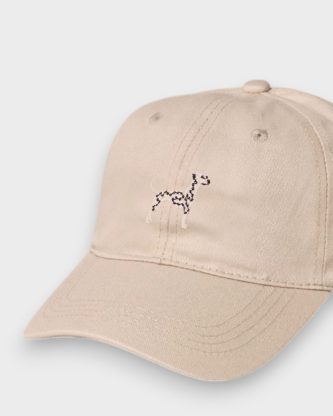 Beige Dalmatian personalised baseball hat with hand-drawn Dalmatian embroidery on front, made of 100% washed cotton.