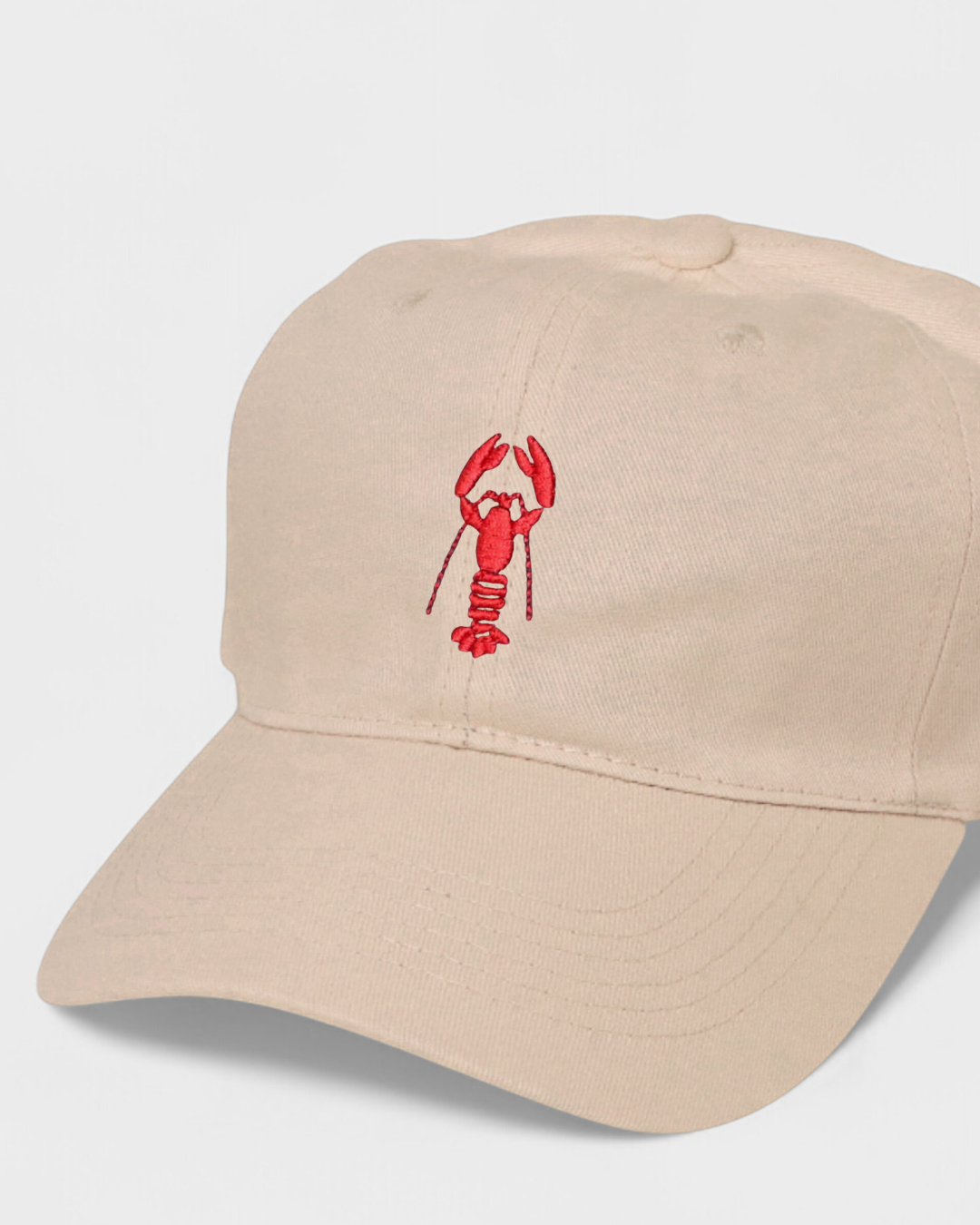 Personalised hat with hand-drawn lobster embroidery design.