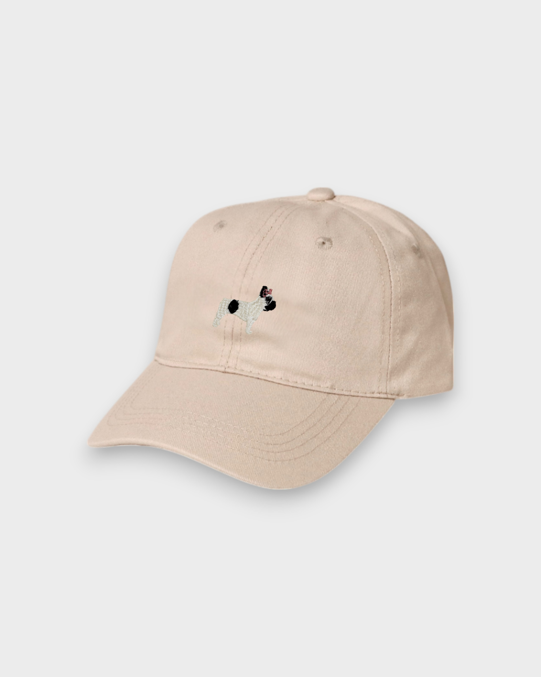 Beige French Bulldog personalised baseball hat with embroidered front design and customisable back embroidery, made of 100% washed cotton.