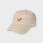 Beige Cavoodle personalised hat with hand-embroidered Cavoodle design on front, made of 100% washed cotton in classic baseball style.