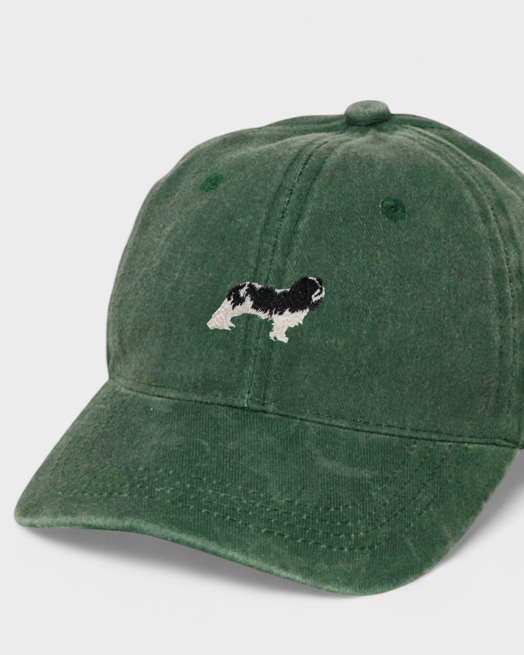 Green baseball cap with embroidered King Charles Spaniel design and personalized back embroidery option