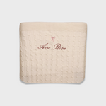 Merino baby blanket with embroidered bow and personalized name in soft cream wool