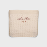 Merino baby blanket with personalized embroidery and vintage rosette design