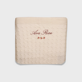 Merino baby blanket with personalized embroidery and vintage rosette design