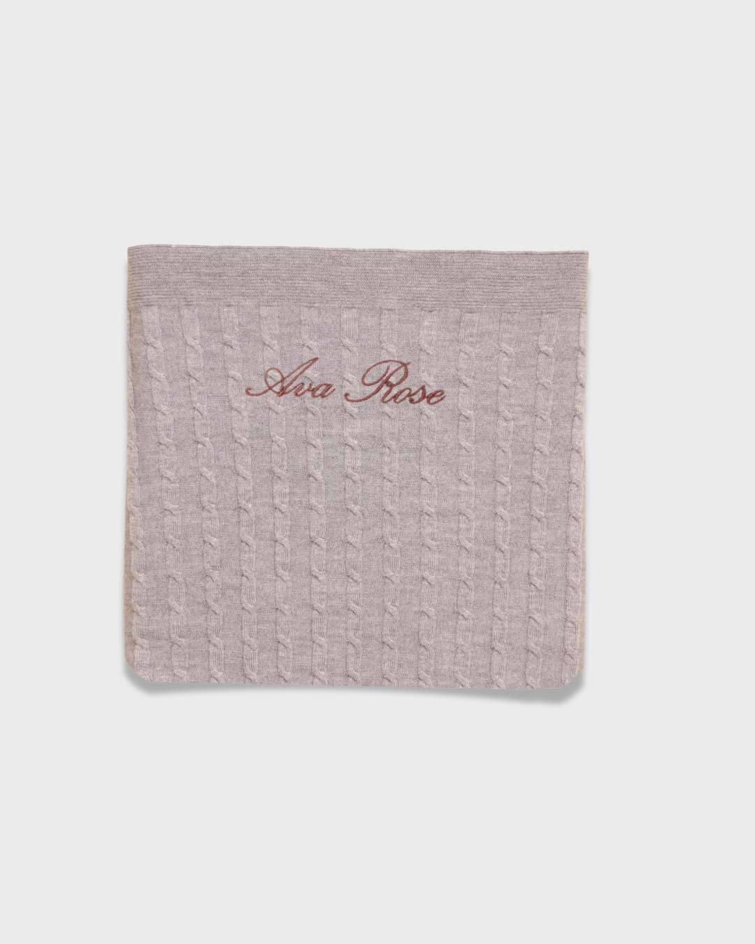 Soft knitted Merino baby blanket with personalized embroidery on natural wool fibers