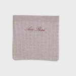 Soft knitted Merino baby blanket with personalized embroidery on natural wool fibers