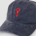 Navy blue baseball cap with red lobster embroidery on front, personalised hat design.