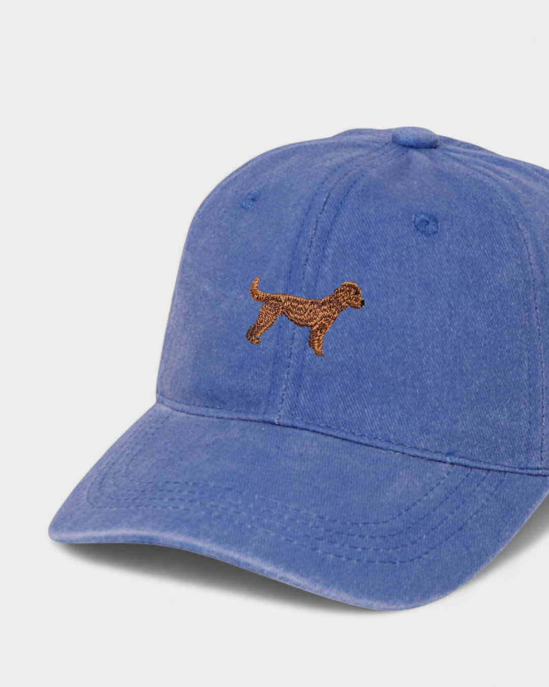 Blue baseball cap with embroidered brown Goldendoodle dog and customizable back embroidery