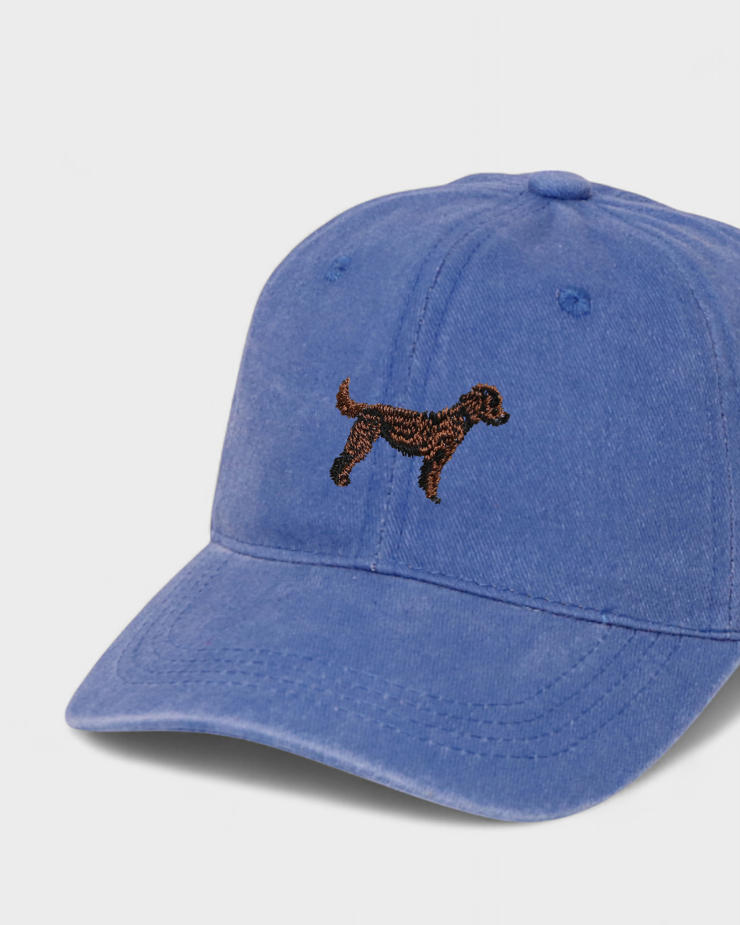 Blue personalised hat with embroidered Labradoodle dog design on front, made of 100% washed cotton in classic baseball fit