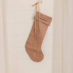 Personalised plain linen stocking with Nordic Cross Stitch name embroidery hanging on wall