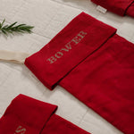 Personalised red linen stocking with custom Nordic Cross Stitch names for Christmas decoration