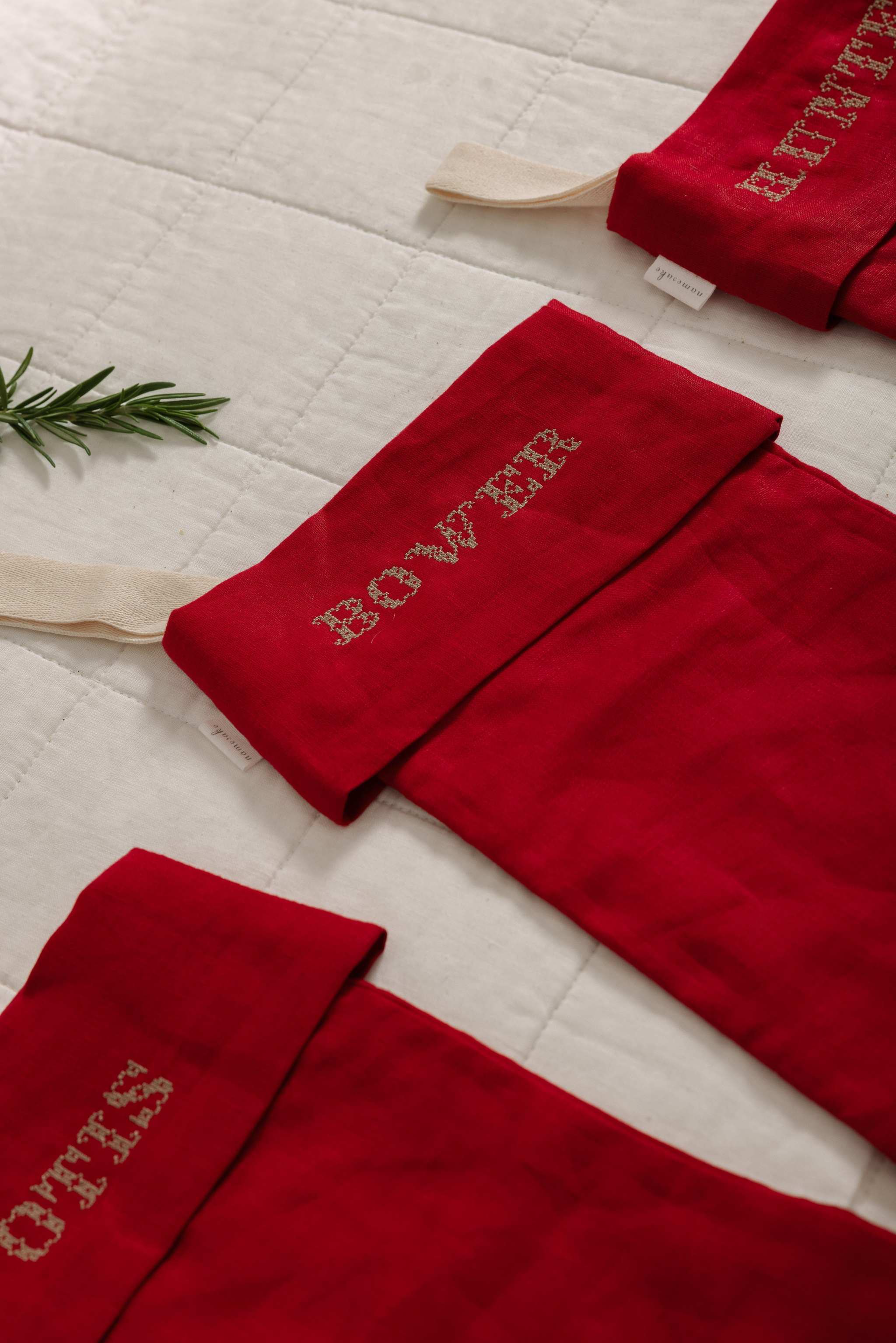Personalised red linen stocking with custom Nordic Cross Stitch names for Christmas decoration